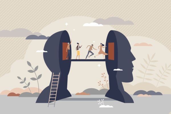 An illustration of a head split in two. A ladder leading up one-half, with a bridge connecting to the other half and people crossing the bridge.